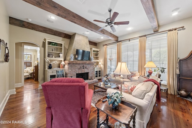 living room with plenty of natural light and dark hardwood / wood-style flooring