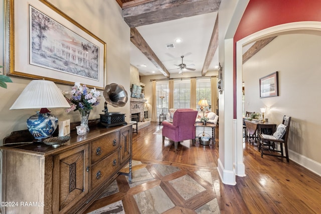 interior space with hardwood / wood-style flooring, ceiling fan, and beam ceiling