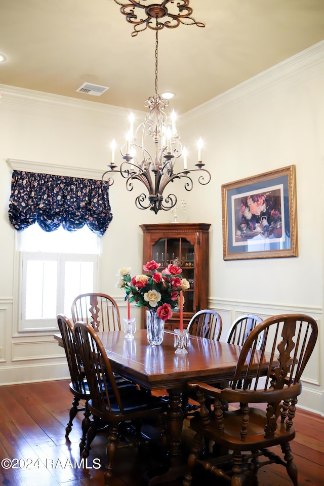 dining area with crown molding and dark hardwood / wood-style flooring