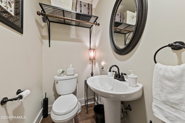 bathroom with wood-type flooring and toilet