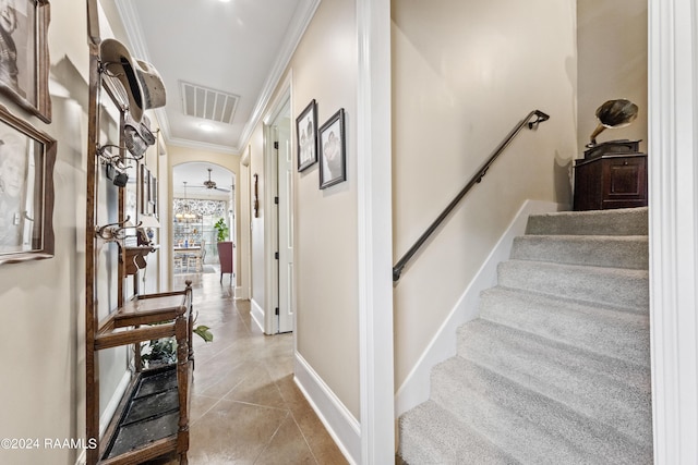 interior space with crown molding and tile patterned floors