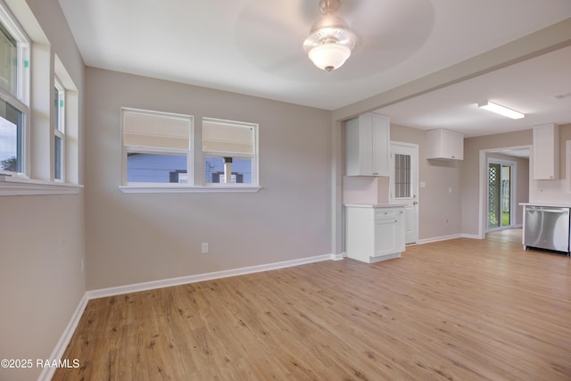 unfurnished living room with ceiling fan and light hardwood / wood-style flooring