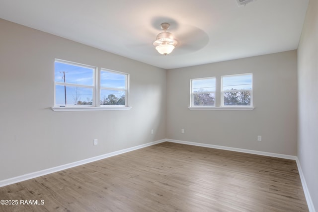 spare room with hardwood / wood-style floors and a healthy amount of sunlight