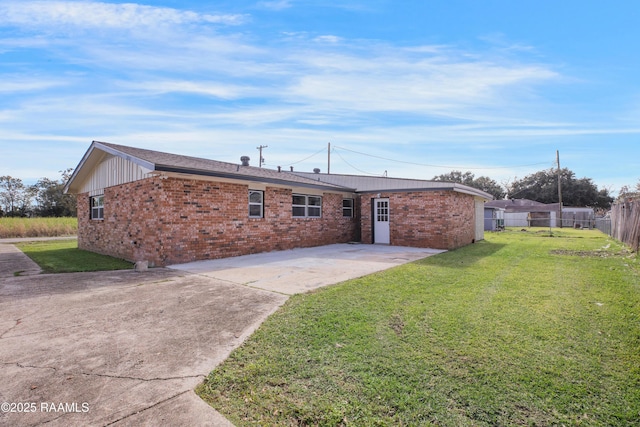 back of house featuring a yard and a patio area