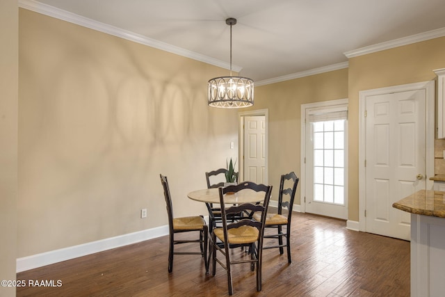 dining area featuring dark wood-type flooring, ornamental molding, and an inviting chandelier