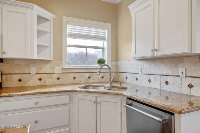 kitchen featuring white cabinetry, dishwasher, sink, and tasteful backsplash