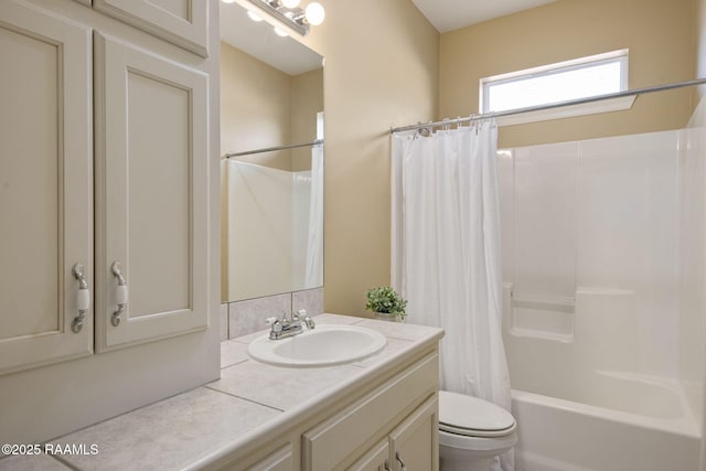 full bathroom with vanity, shower / bath combination with curtain, and toilet