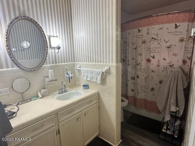 bathroom featuring vanity, toilet, and walk in shower