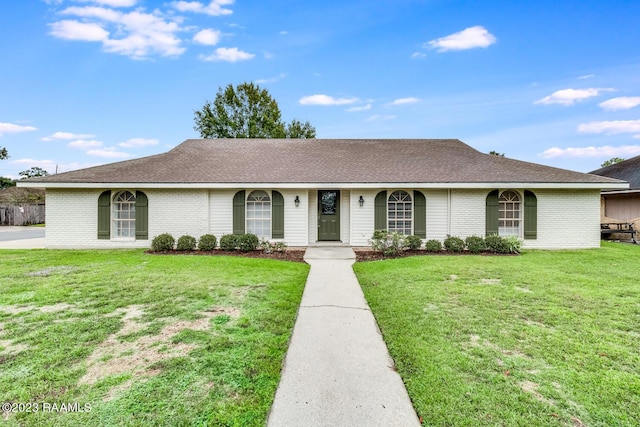 ranch-style home with a front lawn