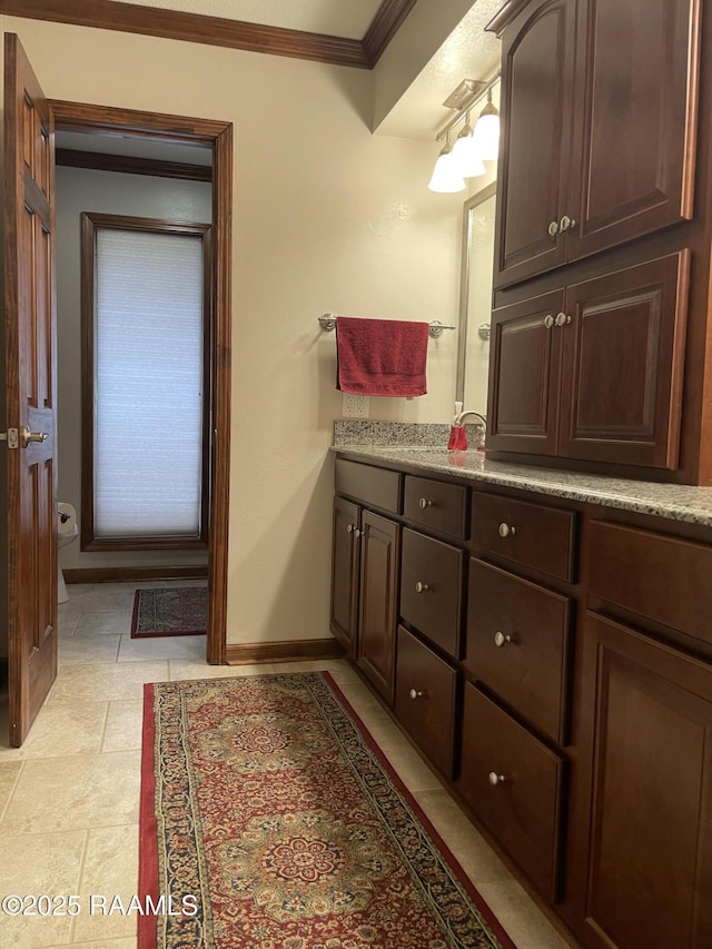 bathroom featuring vanity and ornamental molding