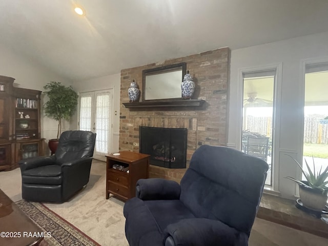 living room with carpet floors, a fireplace, and vaulted ceiling