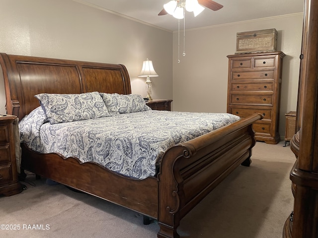 carpeted bedroom featuring ceiling fan and ornamental molding