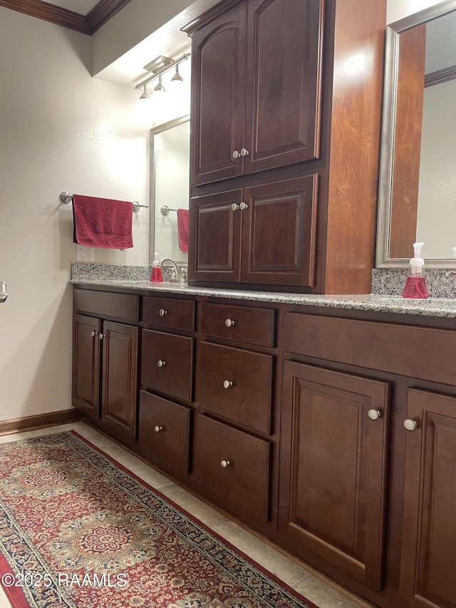 bathroom with ornamental molding and vanity