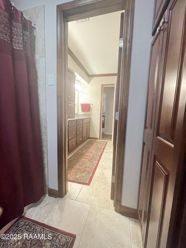 bathroom with crown molding, vanity, curtained shower, and vaulted ceiling