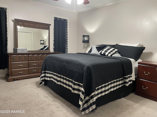 carpeted bedroom featuring ceiling fan and ornamental molding