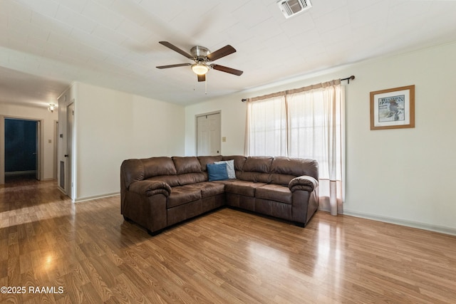 living room with hardwood / wood-style flooring and ceiling fan