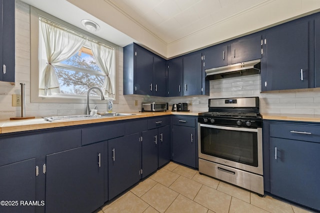 kitchen with blue cabinets, sink, backsplash, light tile patterned floors, and gas range