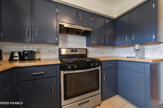 kitchen featuring light tile patterned flooring, butcher block countertops, tasteful backsplash, stainless steel gas range oven, and blue cabinetry