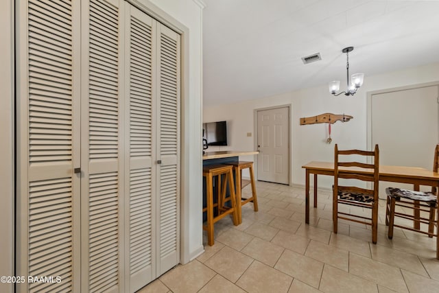 dining space featuring a chandelier and light tile patterned floors