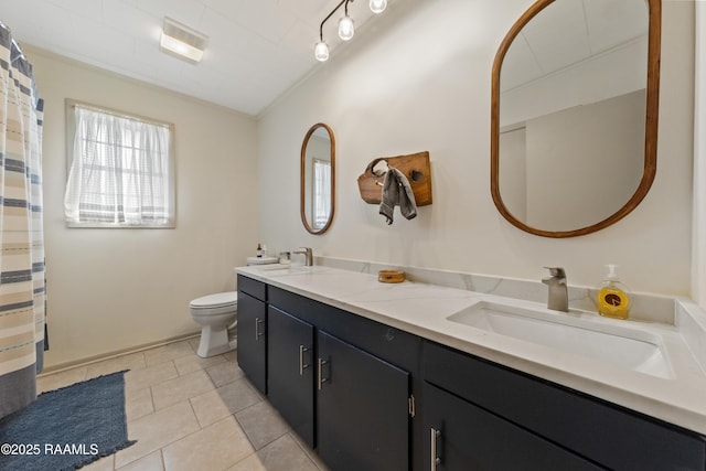 bathroom featuring tile patterned flooring, vanity, crown molding, and toilet