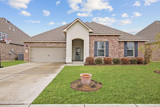 view of front of house with a garage, a front yard, and central air condition unit