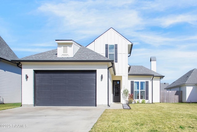 view of front of house with a garage and a front lawn