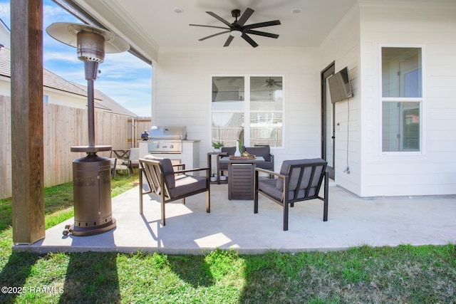 view of patio with an outdoor living space, area for grilling, and ceiling fan