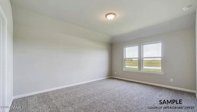 unfurnished room with lofted ceiling and carpet floors