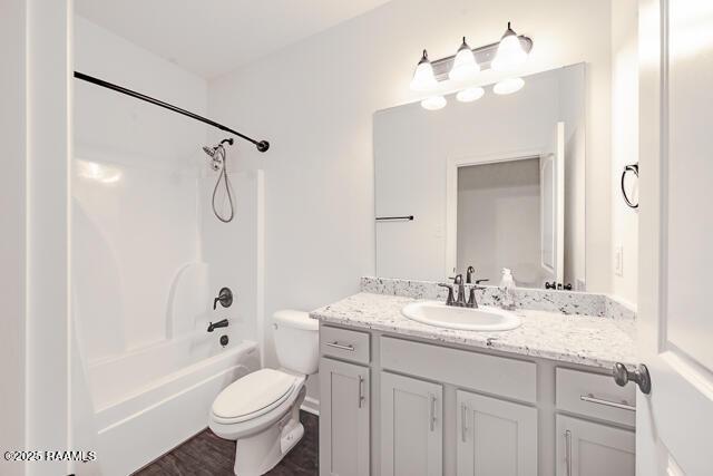 full bathroom with vanity, toilet, shower / bath combination, and hardwood / wood-style floors