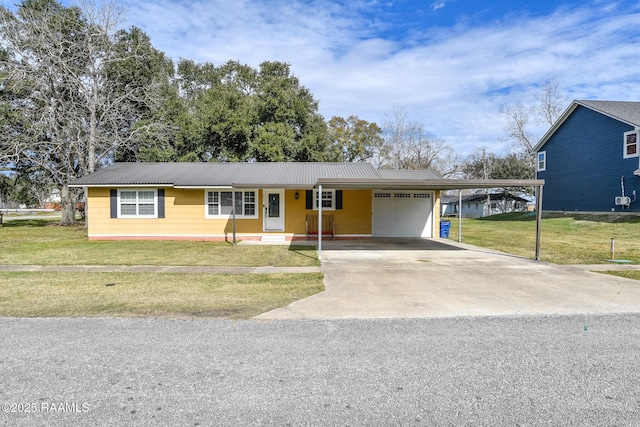 view of front of property featuring a carport, a garage, and a front lawn