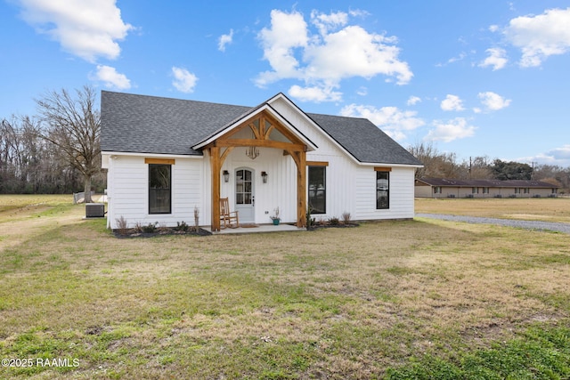 modern farmhouse with central AC and a front yard