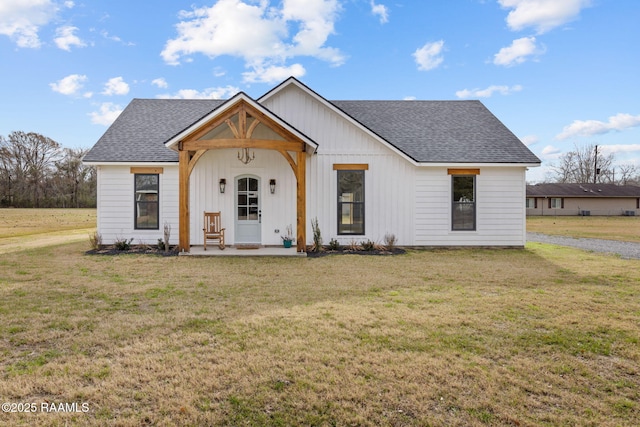 modern inspired farmhouse with a front lawn