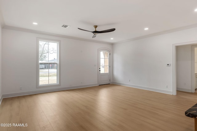 empty room featuring crown molding, ceiling fan, and light wood-type flooring