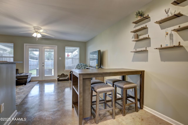 dining area featuring french doors and ceiling fan