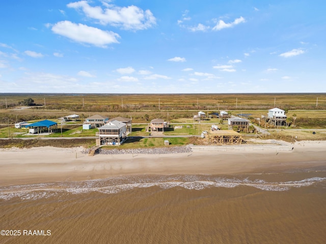 aerial view featuring a water view and a beach view