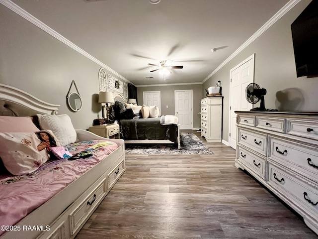 bedroom with hardwood / wood-style flooring, ornamental molding, and ceiling fan