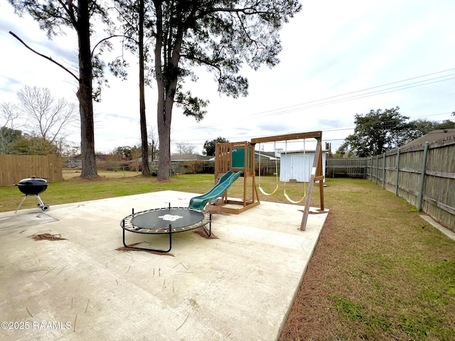 view of playground with a yard and a patio