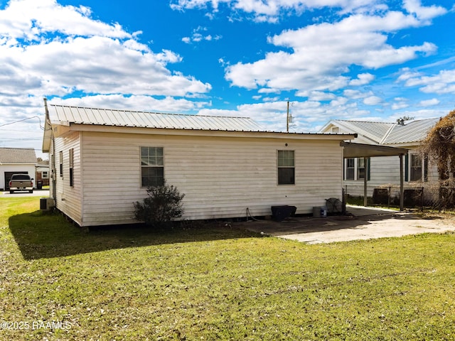 back of house with a yard and a patio