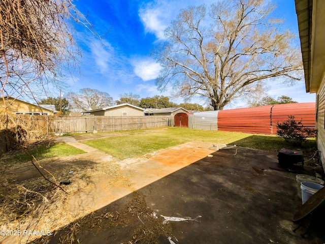 view of yard with a patio and a storage shed