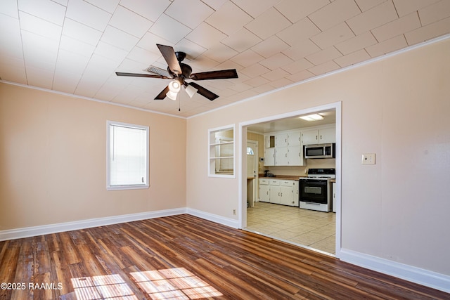 unfurnished living room featuring ornamental molding, ceiling fan, and light wood-type flooring