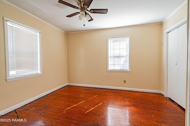 unfurnished bedroom with hardwood / wood-style flooring, ceiling fan, ornamental molding, and a closet