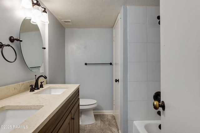 full bathroom with shower / bath combination, vanity, a textured ceiling, and toilet