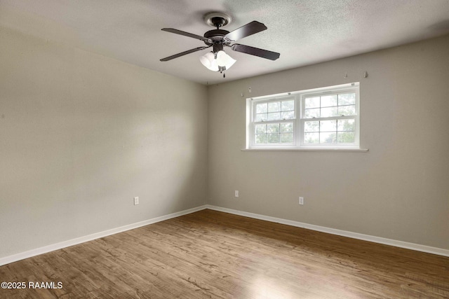 spare room featuring light hardwood / wood-style flooring and ceiling fan