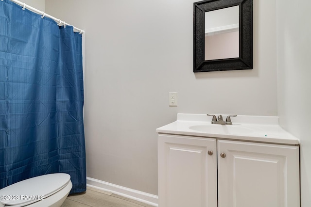 bathroom with vanity, tile patterned flooring, curtained shower, and toilet