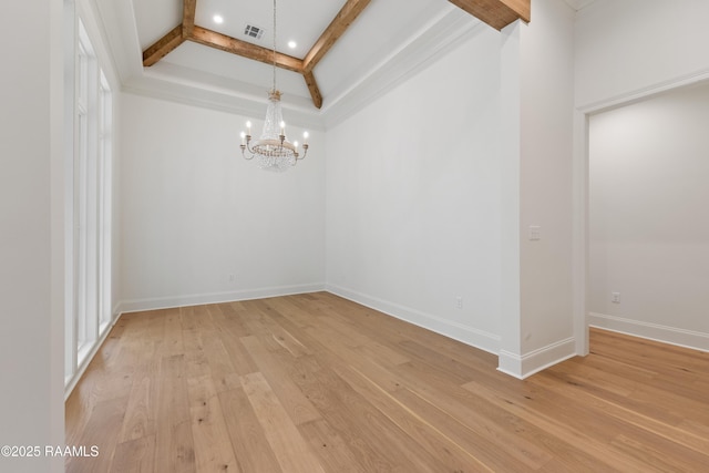 spare room featuring coffered ceiling, an inviting chandelier, crown molding, light hardwood / wood-style flooring, and beam ceiling