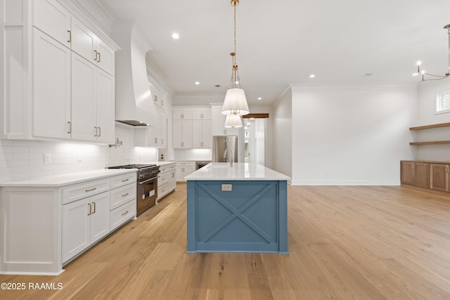 kitchen featuring pendant lighting, white cabinets, and appliances with stainless steel finishes