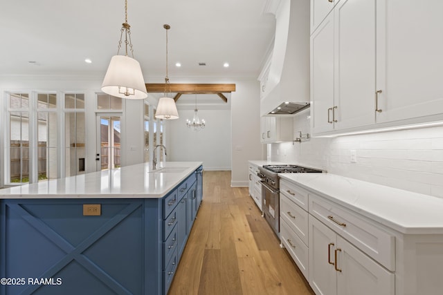 kitchen featuring white cabinetry, sink, pendant lighting, and a spacious island