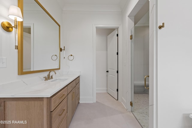 bathroom with tile patterned flooring, vanity, an enclosed shower, and crown molding