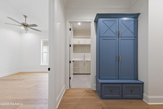 hall with sink and light hardwood / wood-style flooring