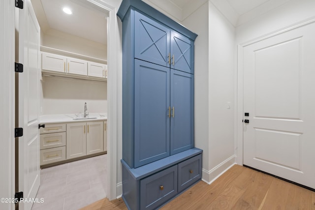 mudroom featuring sink and light hardwood / wood-style floors